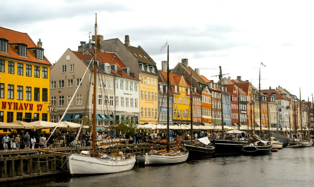 Photographer documenting a local market scene in a Danish town